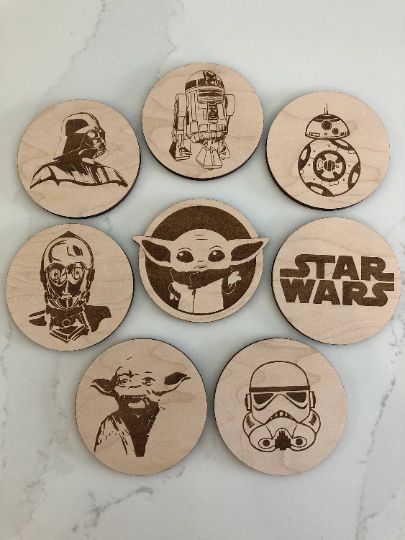 These laser engraved coasters are a perfect gift for all Star Wars lovers! They measure 3.5 diameter. SVG is ready to cut and engrave on a laser cutter. You can sell the physical product but you cannot sell or distribute the digital files in any way.If you have any questions with the file, please contact me directly. Do you love DIY projects? Do you want to create something unique and amazing for your loved ones? Then you should try laser cut files! Laser cut files are digital designs that Star Wars Coasters, Star Wars Party Decorations, Laser Cut Coaster, Engraved Coasters, Laser Cut Wood Crafts, Star Wars Set, Laser Engraved Ideas, Star Wars Inspired, Wooden Stars