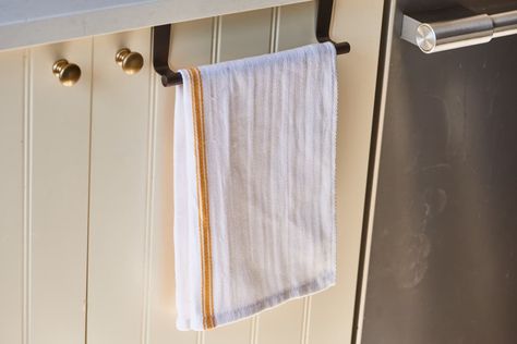 Kitchen Sink Towel Bar Organizing Hack | Kitchn Kitchen Towel Hanging Ideas, Kitchen Towels Storage, Towel Holder Diy, Kitchen Towels Diy, Under The Kitchen Sink, Kitchen Towels Crafts, Kitchen Towels Hanging, Kitchen Sink Storage, Kitchen Towel Holder