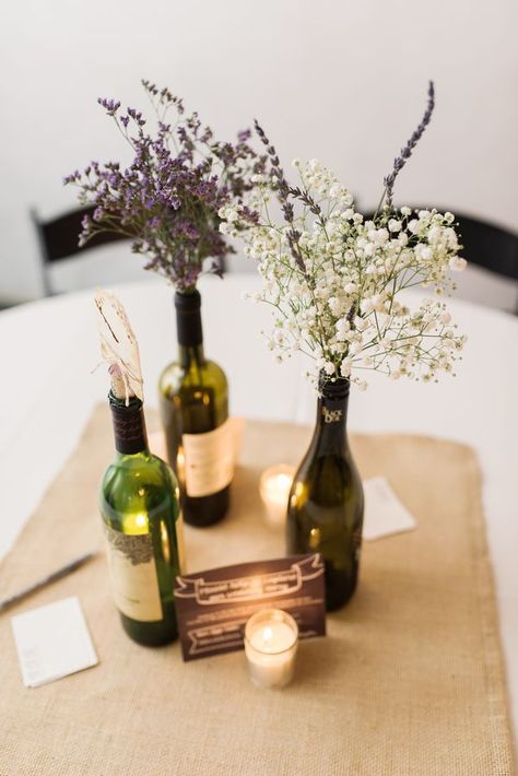 Baby's breath with lavender in wine bottles. Combine these with sheet music flowers for bouquet! Diy Centre Pieces, Wine Bottle Flowers, Cheap Wedding Table Centerpieces, Wedding Table Toppers, Diy Lavender, Expensive Flowers, Wine Bottle Centerpieces, Wedding Wine Bottles, Bottle Centerpieces