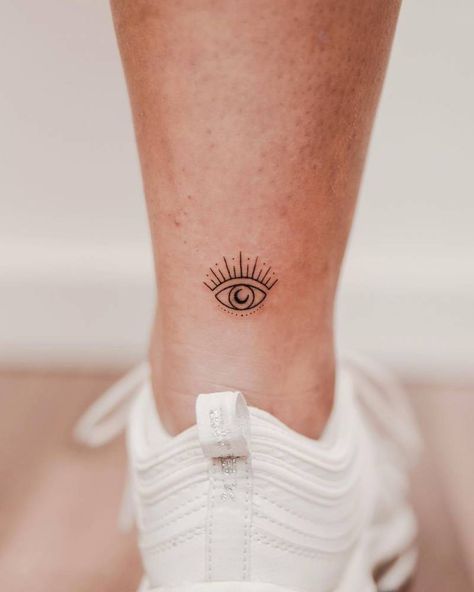 Minimalist evil eye tattoo on the achilles. Greek Evil Eye Tattoo, Anatomy Eyes, Under Eye Tattoo, Third Eye Tattoos, Rare Tattoos, Evil Eye Tattoo, Stylist Tattoos, Sternum Tattoo, Time Tattoos