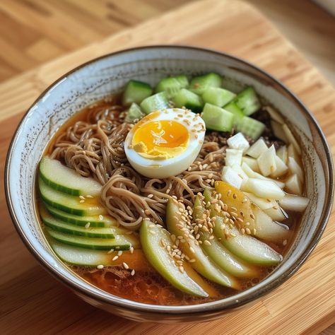 🥢 Experience the unique taste of Korean Cold Noodles! #KoreanCuisine 🍽️ Korean Cold Noodles (Naengmyeon) 🛒 Ingredients: Naengmyeon noodles: 1 package Beef broth: 2 cups, chilled Cucumber: 1/2, julienned Pear: 1/2, julienned Boiled egg: 1, halved Vinegar: 1 tbsp Mustard sauce: 1 tsp 👩‍🍳 Instructions: Prepare: Cook noodles, rinse under cold water. Serve: Place noodles in a bowl, pour chilled broth. Top: Add cucumber, pear, and egg. Drizzle with vinegar and mustard. 🌟 Enjoy this refreshing d... Naengmyeon Recipe, Korean Cold Noodles, Instagram Recipes, Cold Noodles, Mustard Sauce, Trending Recipes, Boiled Egg, Beef Broth, Boiled Eggs