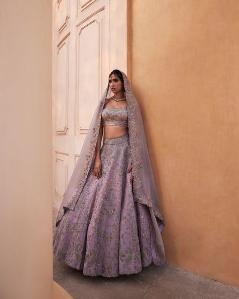 MRUNALINI RAO on Instagram: "Featuring Bridal 2023: Leela Florette Lehenga An all-over resham jaal highlighted with speckles of zardozi elevates this charming lehenga in Lilac. Paired with a hand-embroidered U-neck blouse and dupatta with an embroidered border. #mrunalinirao #somethingnew #bridal #hyderabad #intricacy #craftmanship Photographer: @prithvipictures Jewellery: @sanjaygupta.world Stylist: @jukalker Make-up and hair: @sadhnasingh1 and @hairbyrajabali Talent: Aksharaa J and Mona B Wedding Lehengas Bridal, Lilac Lehenga, Mrunalini Rao, Bridal 2023, Floral Lehenga, Lilac Wedding, Indian Bridal Fashion, Embroidered Border, Indian Couture