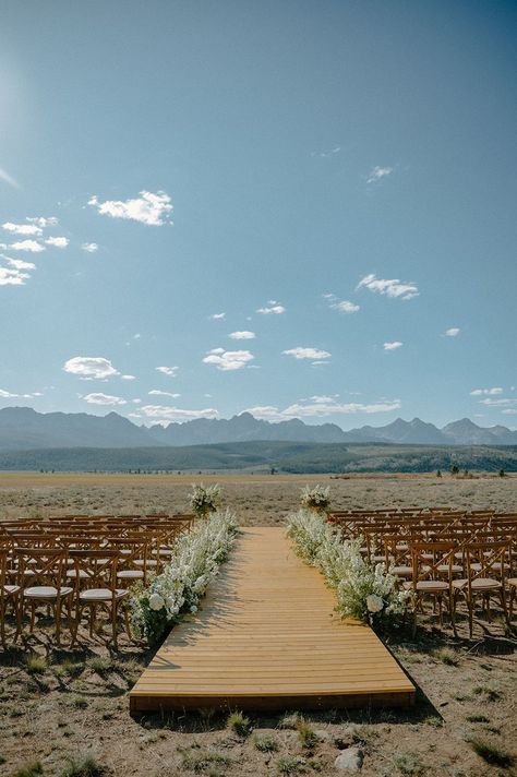 This couple had a luxury wedding with a custom wooden plank wedding aisle and a flower explosion lining the ceremony aisle #weddingaisle #weddingceremonydetails #weddingceremonydesign #weddingaltar #aisle #ceremonyflowers #ceremonyflorals #weddingceremonyaisle #luxurywedding #mountainwedding #mountainweddings #weddingdesign #weddinginspiration #weddingdecor #summerwedding #outdoorwedding #luxuryweddingdesign #weddinginspo #weddingphotography #weddingvenue #mountains Wood Aisle Runner, Woods Wedding Ceremony, Idaho Wedding Venues, Aisle Ideas, Mountain Ranch Wedding, Flower Explosion, Wedding Isles, Ceremony Aisle, Ceremony Details