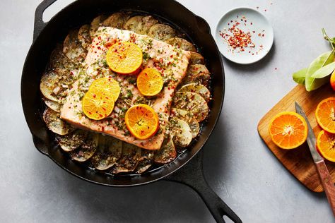 Citrus-dressed salmon roasted over potatoes is a quick, flavorful one-pan meal that is perfect for any night of the week Skin-on Yukon Golds are thinly sliced, fanned out and generously drizzled with a citrus sauce to serve as the base for the meal The salmon is placed directly on top of the potatoes after they’re briefly roasted, the fish is drizzled with more sauce, then everything roasts together until the salmon is tender and the potatoes are perfectly cooked through and irresistibly tangy Salmon And Potatoes, Seafood Meals, Roast Fish, Citrus Dressing, Nyt Cooking, Cooking Salmon, Roasted Salmon, One Pan Meals, Potatoes Recipe