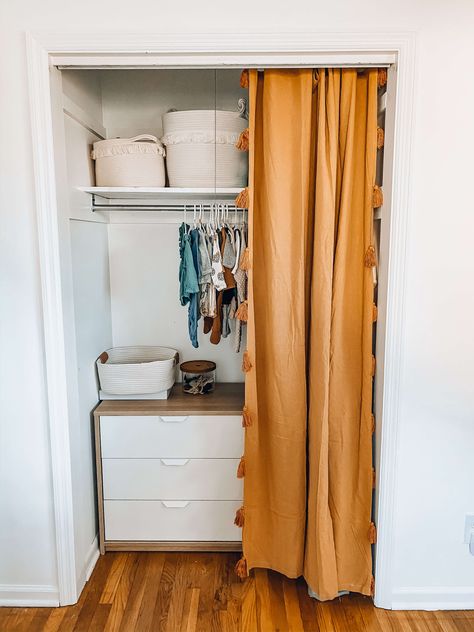 This neutral boho nursery is a simple and clean nursery for baby girl that is peaceful and soothing. With bohemian and modern touches, this room is perfect for any baby and mama. Love the closest organization and pop of color from the curtain. This post contains links to all the furniture and decor! Use this for ideas for your own nursery. #boho #nursery #neutral #boy #girl #decor #ideas #baby #simple #clean #white Nursery With No Closet Door, Small Nursery Closet Door, Boho Closet Curtains, Closet Curtain Ideas Boho, Nursery Closet Door Ideas, Closet Curtain Ideas Bedroom Boho, Nursery Closet Curtain Ideas, Nursery Closet Without Doors, Nursery Closet No Doors