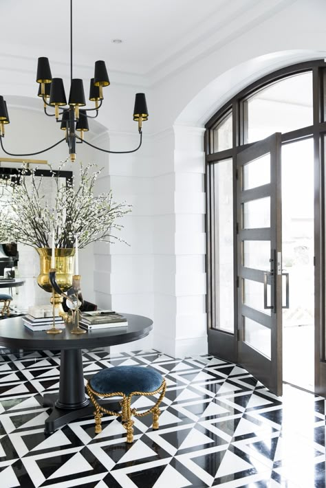 A sophisticated and elegant entryway can set the tone for the rest of a home, designed by Jessica Bennett. Bauhaus Office, Black And White Flooring, White Flooring, Entryway Tile, Foyer Flooring, Millwork Details, Alice Lane, Art Deco Door, Elegant Entryway