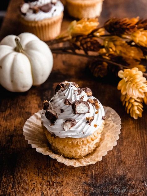 maple cupcake with marshmallow frosting and candy bits; cupcake on unfolded paper liner and dark wood surface Cupcakes With Marshmallow Frosting, Chai Latte Cupcakes, Maple Cupcakes, Marshmallow Fluff Frosting, Sweet Potato Cupcakes, Marshmallow Cupcakes, Maple Cake, Thanksgiving Cupcakes, Marshmallow Frosting