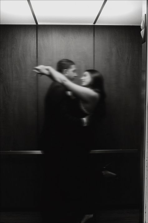 Black and white blurry photo of a couple in an elevator, the girls arms are over the shoulders of the boys Wedding Studio Photography Ideas, Elevator Couple Photos, Couple In Elevator, Nye Couple, Elevator Kiss, Museum Shoot, Elevator Photoshoot, Couple Poses Engagement, Photography Couple Poses