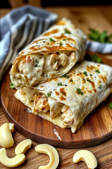 Craving a quick, cheesy delight? These Cheesy Garlic Chicken Wraps are the perfect combination of savory chicken, melted cheese, and garlic goodness. Easy to make and packed with flavor, they’re sure to become a household favorite. Surprise your taste buds – full recipe inside! #CheesyChickenWrap #GarlicChickenWrap #ChickenRecipes #EasyDinner #WrapRecipes #CheesyWraps #GarlicLovers #QuickMeals #EasyWraps #FamilyFavorite #DinnerIdeas #ChickenWraps #CheeseRecipes Garlic Chicken Wraps, Cheesy Garlic Chicken Wraps Recipe, Chicken Ceaser Wraps Recipe, Cheesy Garlic Chicken Wraps, Chicken Cheese Steak, Cheesy Garlic Chicken, Grilled Chicken Wraps, Feta Cheese Recipes, Chicken Wrap Recipes