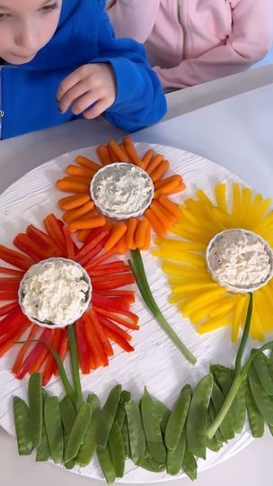 588K views · 17K reactions | EASY FLOWER CRUDITE PLATTER!!🌼🌸 SAVE & SHARE this adorable veggie platter idea!! Perfect for spring and summer parties and mothers or Easter Day!!

LIKE + COMMENT “flower” - I will send you all the details and full recipe! This is so easy to make and adorable for all your parties! Only way I will be serving veggies this summer!

FOLLOW ME @athomewith.shannon for more easy recipes and fun ideas!! #charcuterie #charcuterieboard #veggie #veggieplatter #easyrecipeideas #easyrecipe #momhack | Shannon Doherty | Wuki · Sunshine (My Girl) Flower Shaped Veggie Tray, Veggie Flower Charcuterie, Sunflower Vegetable Tray, Charcuterie Board Ideas For Mother’s Day, Sunflower Fruit Platter, Sunflower Veggie Tray, Veggie Flowers Food Art, Flower Veggie Tray, Flower Fruit Tray