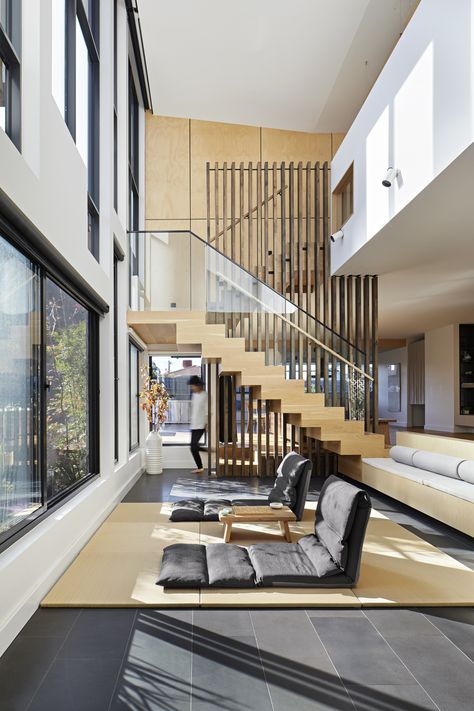 A stair with freestanding cross laminated timber balustrade becomes the design feature of this sunny double-volume living area in a Melbourne house. (design by Urbourne Architecture, photo by Tatjana Plitt) Contemporary Long House, Freestanding Staircase, Double Volume House, Double Volume, Double Volume Staircase, Double Volume Stairs, Staircase To Mezzanine Floor, Central Stringer Staircase, Central Staircase Architecture