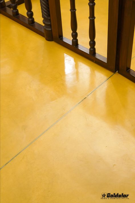 A beautifully designed yellow oxide floor, emanating warmth and radiance, enhances the ambiance of the entire room Yellow Oxide Flooring, Oxide Flooring, Yellow Flooring, Yellow Tongue, Cement Flooring, Yellow Floor, Kitchen Revamp, Floor Refinishing, Garage Room