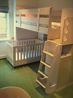 This design is ideal when there is an age difference of at least five years between siblings. Two sisters, a six-year-old and baby, share this room. The specially designed crib is set low to the ground to maximize space beneath the bottom of the loft and access to the child in the crib. The bunk bed features a landing that slows a child as he or she moves up and down the stairs for added safety. Toddler And Baby Room, Sibling Room, Toddler Cot, Kids Rooms Shared, Shared Kids Room, Bunk Beds With Stairs, Bunk Bed Designs, Space Bedding, Shared Bedroom