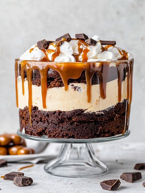 Salted Caramel Brownie Cheesecake Trifle 🍫🍮  🍮 𝗜𝗻𝗴𝗿𝗲𝗱𝗶𝗲𝗻𝘁𝘀 🍮 For the Brownie Base: 1 box (18-20 oz) brownie mix (plus ingredients called for on the box: water, oil, eggs) 8 oz salted caramel (jarred or homemade) Cheesecake Layer: 2 (8 oz) packages cream cheese (softened) 1/2 cup sugar 2 teaspoons vanilla extract or vanilla bean paste 1 cup heavy cream (whipped to stiff peaks) Whipped Cream Topping: 1 cup heavy cream 1/4 cup powdered sugar Garnish: Chocolate-covered caramels Salted Caramel Brownie Cheesecake Trifle, Brownie Cheesecake Trifle, Garnish Chocolate, Caramel Brownie Cheesecake, Punch Bowl Cake Recipe, Orange Juice Cake, Trifle Bowl Recipes, Salted Caramel Brownie, Punch Bowl Cake