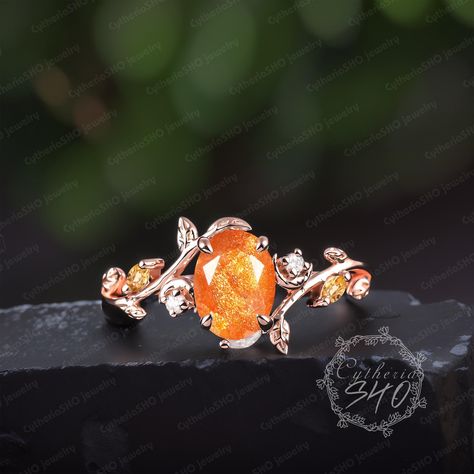 Unique oval cut sunstone engagement ring Art deco 14K rose gold leaf moon promise ring Nature inspired Orange Gemstone ring Her jewelry gift Engagement ring Center Stone: Sunstone Cut: Oval cut Size: 6*8mm Side stone: Citrine + Moissanite Weight: 0.12ctw Width: 1.5mm Thickness: 1.2mm Wedding band Stone: Citrine + Moissanite Weight: 0.11ctw Width:1.3mm Thickness: 1.2mm Ring Metal: 925 sterling silver or 10K/14K/18K Yellow/ White/Rose Gold or platinum  Or Black color: The underneath metal is in Silver/ 10K/14K/18K white gold, coated with black rhodium Processing time Dute to all our jewelry are made to order for each customer.Your package will ship within 3-4 weeks of purchase.We need to ensure the quality of each jewelry.Thank you for your patience.  More Information *Custom Order *Rush Ord Orange Wedding Ring, Orange Engagement Ring, Amber Engagement Ring, Sunstone Engagement Ring, 2mm Wedding Band, Citrine Engagement Ring, Citrine Ring Engagement, Unique Promise Rings, Rose Gold Leaf