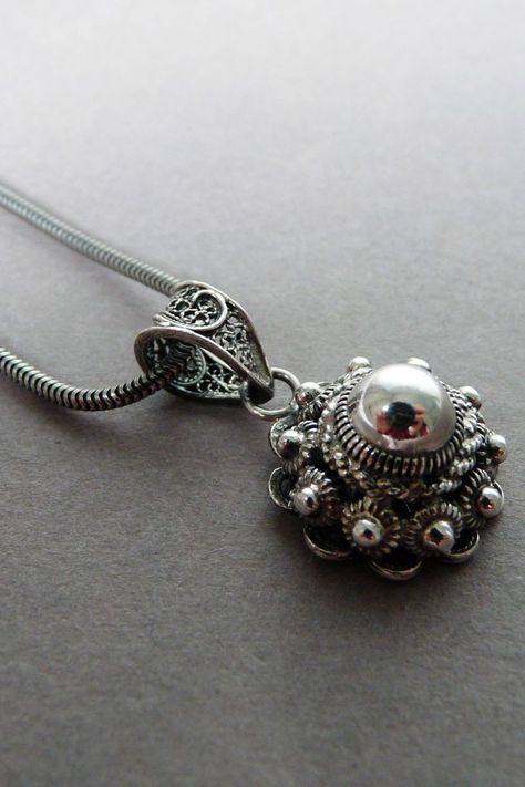 A Sterling silver necklace with a 16 mm traditional Dutch button pendant charm. These typical Dutch buttons date from the 17th century and were made from silver or gold. The size of the knot indicated the wealth and importance of the wearer. Combine this necklace to layer with others or simply wear it on it's own. The silver necklace is 1.8 mm thick and measures 42 cm in length Gold And Silver Jewelry Together, Folklore Jewelry, Dutch Traditions, Button Pendant, Necklace Traditional, Knot Jewelry, Dutch Style, Button Necklace, Ring Inspo