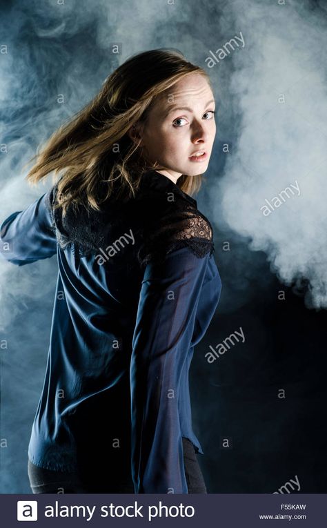 Download this stock image: Scared young woman running away in the dark looking over shoulder - F55KAW from Alamy's library of millions of high resolution stock photos, illustrations and vectors. Running And Looking Back Reference, Running While Looking Back Pose Reference, Running Looking Back Reference, Looking Back Over Shoulder Pose, Person Looking Over Their Shoulder, Person Looking Behind Shoulder Reference, Person Looking Back Over Shoulder, Girl Looking Back Over Shoulder, Scared Photography