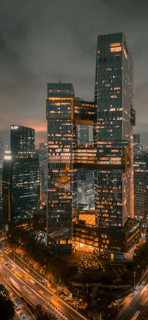 Image of a skyscraper at night surrounded by lights Skyscraper Wallpaper, Skyscrapers Wallpaper, Skyscrapers At Night, Wallpaper Dark, Dark Wallpaper, At Night, New York Skyline, Skyscraper, Multi Story Building