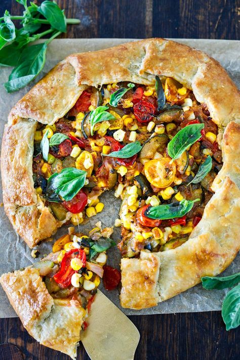 This savory galette is filled with summer tomatoes, corn, and zucchini, with ricotta, basil and parmesan baked in a free-form pie crust. Things To Do With Pie Crust Dinner, Pizza With Pie Crust, Zucchini Ricotta Galette, Mediterranean Vegetable Galette, Galette Recipe Savory, Savory Tomato Galette, Vegan Galette Savory, Tomato Galette With Basil Pesto & Feta, Grilled Broccolini