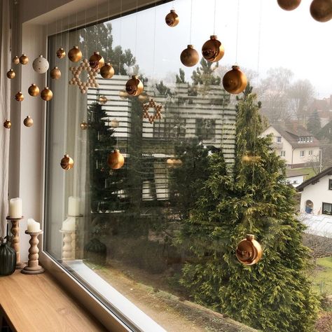 15 Ways to Decorate Your Home with Snowflakes and Baubles  #Christmasdecorations #Christmasornaments, Christmas Decoration Bauble Hanging Ideas, Christmas Bauble Window Display, Ornaments In Window Hanging, Hanging Baubles Decoration, Floating Ornaments From Ceiling, Christmas Ornaments Hanging From Ceiling, Hang Ornaments From Ceiling, Hanging Christmas Decorations Ceiling, Ornaments On Ceiling