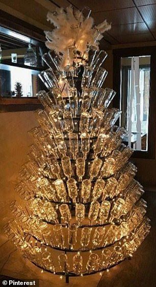 The DIY craze involves wrapping strings of fairy lights around tiered bottle racks, and st... Wine Themed Christmas Tree, Diy Wine Bar, Disney Diy Christmas Ornaments, Wine Christmas Tree, Wine Bottle Christmas Tree, Bottle Christmas Tree, Wine Bottle Trees, Wine Bottle Garden, Recycled Christmas Decorations