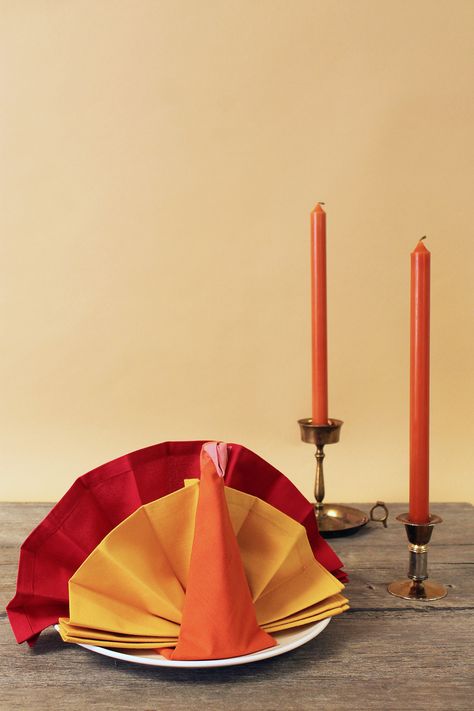 For a Thanksgiving feast, this triple-napkin turkey with a fanning tail makes a bold statement from the moment your guests sit at the table. Turkey Napkin Fold, Bow Tie Napkins, Napkins Folding, Thanksgiving Napkin Folds, Fold A Napkin, Christmas Tree Napkin Fold, Turkey Napkins, Folding Ideas, Christmas Tree Napkins