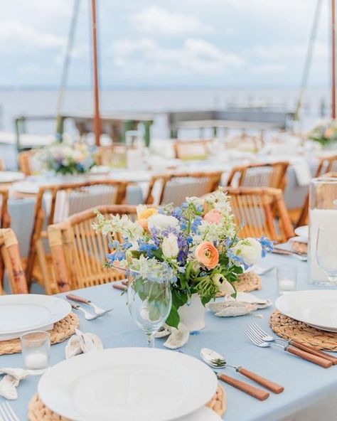 Jerrye Gordon Events on Instagram: "We love a coastal wedding. We focused on textures for this one. Tortoise shell bamboo chairs, hyacinth chargers and wooden handled flatware were the perfect combination to create a simple coastal style for this couples big day! . . Lens by @glynnischristensenphotography . . #coastalbride #coastalwedding #coastalweddings #crystalcoastbride #crystalcoastweddings #ncwedding #ncweddings #ncweddingvenue #ncweddingplanner #ncweddingdesigner #weddingplanner #weddin Coastal Blue Wedding Decor, Beachy Reception, Coastal Wedding Bridesmaids, Minimalist Coastal Wedding, Romantic Coastal Wedding, Coastal Cottage Wedding, Winter Coastal Wedding, Coastal Blue Wedding Color Palettes, Nantucket Style Wedding