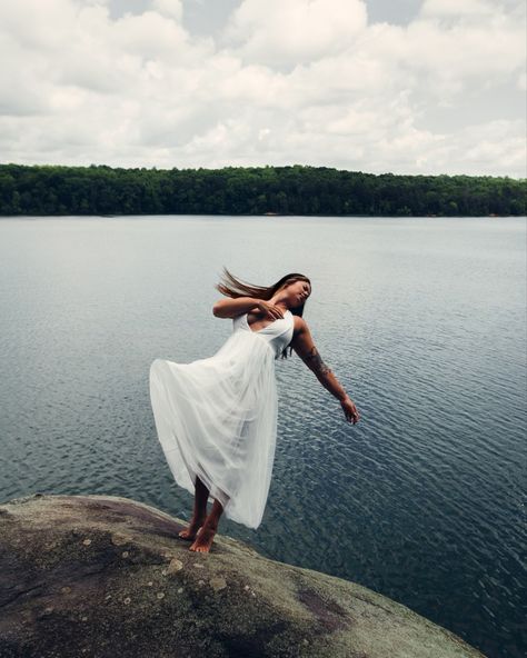 Girl falling into lake in long dress Falling Into Water Photography, Person Falling Off Cliff, Girl Falling Off Cliff, Falling Photoshoot, Falling Photography, Falling Off A Cliff, White Dress Fall, Someone Falling, Grad Shoot