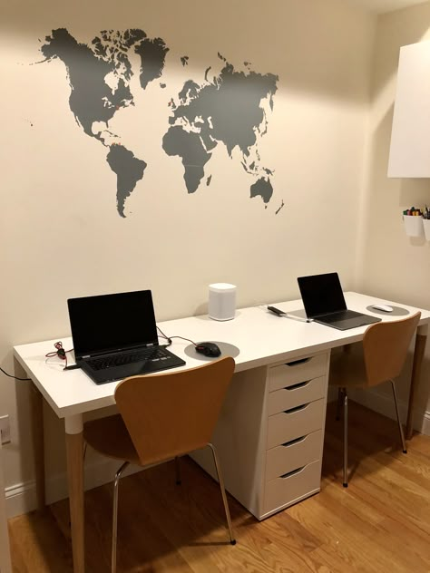 Double desk from IKEA and world map wall decal 3 Person Ikea Desk, Small Double Office Layout, Ikea 2 Person Desk, Ikea Double Desk Hack Kids, Ikea Double Desk Hack, Small Space Double Desk, Double Workstation Desk, Ikea Double Desk, Double Desk Ideas