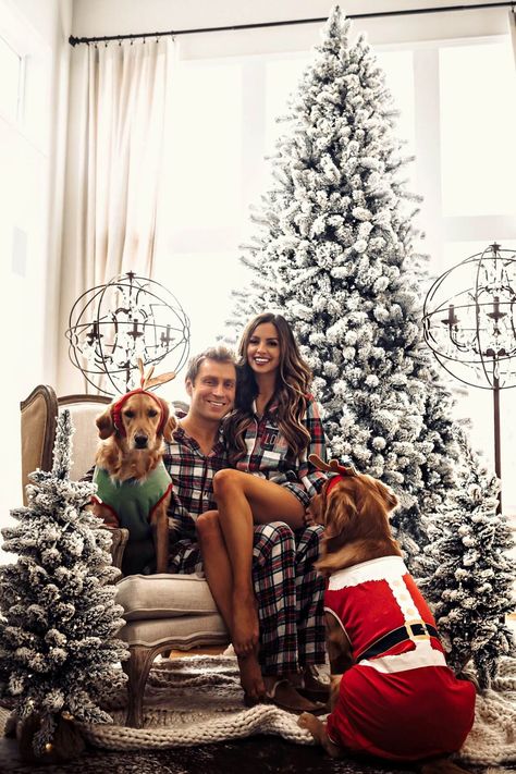 fashion blogger mia mia mine wearing a plaid christmas romper pj set with husband and dogs. click through to see my favorite matching pajamas for the family, matching christmas pajamas, holiday pajamas, and christmas traditions. #holidaypjs #christmas #christmastree Christmas Photoshoot Family Pajamas, Couple Christmas Pictures With Dog Pajamas, Bedroom Christmas Pictures Family, Christmas Dog Family Photoshoot, Couple Christmas Pajamas Photoshoot, Christmas Pictures On Bed, Matching Christmas Pajamas With Dog, Pajama Pictures, Christmas Couple Pajamas