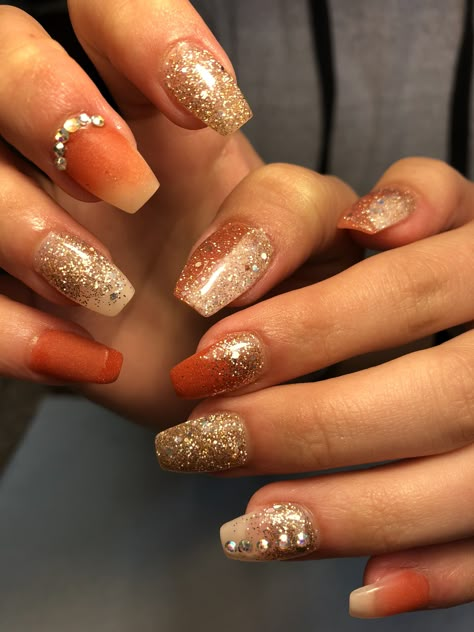 Burnt orange and gold glitter nails Orange Gold Nails Design, Wedding Nails Orange, Burnt Orange Prom Nails, Orange And Gold Nails Acrylic, Burnt Orange Wedding Nails, Gold Orange Nails, Burnt Orange Ombre Nails, Burnt Orange And Gold Nails, Orange Wedding Nails