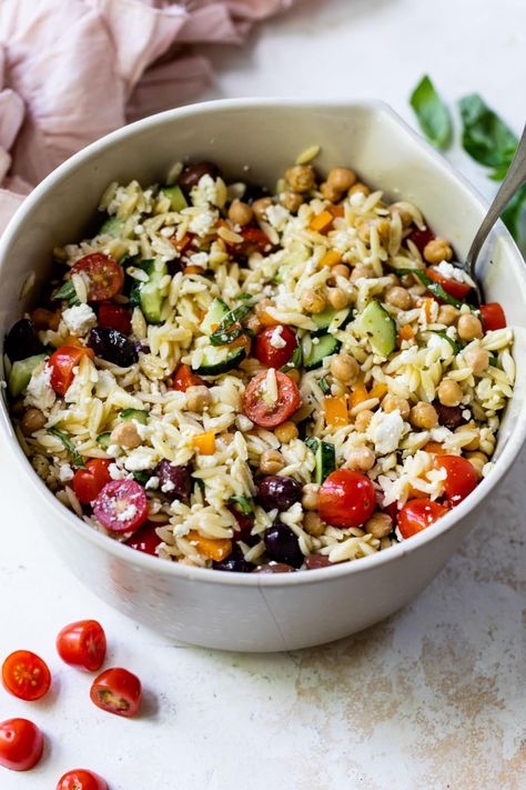 This Greek-inspired orzo pasta salad recipe is loaded with Mediterranean flavor thanks to the feta, olives, chickpeas, and basil. Delish! Greek Orzo Pasta Salad Recipe, Greek Orzo Pasta Salad, Greek Orzo Pasta, Orzo Pasta Salad Recipe, Rice Salads, Greek Orzo, Feta Pasta Salad, Potato Salad Healthy, Grilled Chicken Tenders