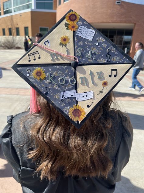 An SUU graduate facing away from the camera, so the top of their grad cap is visible. Their grad cap is decorated with four quadrants of different background paper. There are music note and sunflower stickers, as well as stickers spelling out "Miss Koontz." Piano Graduation Cap, Marching Band Graduation Cap, Grad Cap Music Ideas, Communications Graduation Cap, Music Education Graduation Cap, Music Teacher Graduation Cap, Music Major Graduation Cap, Grad Cap Ideas Teacher, Grad Cap Ideas Music