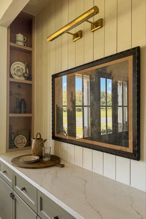 Dining room inspo, picture light, brass, vintage, cottage, cutting board, wood, landscape print, vintage art, wall art, dining nook, wood shelves Picture Lights On Bookcases, Frame Tv With Picture Light, Picture Light Over Art, Light Above Kitchen Sink, Lighting Above Sink, Amsterdam Kitchen, Dining Room Shelving, Light Over Sink, Antique Glass Mirror