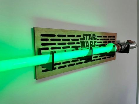 The most perfect lightsaber stand for a star wars fan #geekygifting #gaggifts #coolgifts #geekgifts #giftideas #giftsfornerds #geekstuff #geeked #nerdgifts #coolgadgets #geekystuff #memes #memesdaily #lightsaberhilt #lightsabers Lightsaber Decor, Lightsaber Holder Wall, Lightsaber Display Ideas, Lightsaber Holder, Lightsaber Wall Mount, Legacy Lightsaber, Lightsaber Stand, Lightsaber Display, Star Wars Room Decor