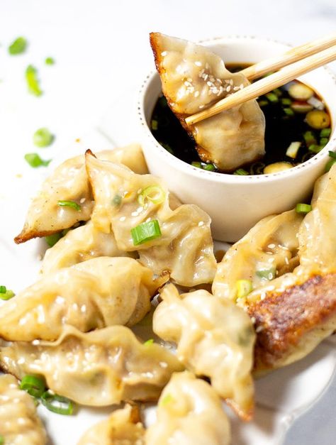 Close up shot of a pork dumpling being dipped in soy sauce with chopsticks Tailgate Food Ideas, Best Holiday Appetizers, Chinese Chicken Recipes, Holiday Appetizers Recipes, Pork Dumpling, Holiday Appetizer, Tailgate Food, Favorite Appetizers, Fried Pork