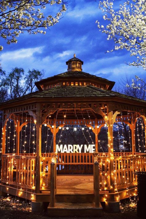 This picture is from 3 years ago when my husband first proposed to me. There was a trail of signs in the park with short phrases on them with reasons why he loved me. The trail of signs led to this beautiful gazebo that he set up. It was the most romantic moment I could’ve ever imagined and I’ll forever cherish it. He covered this gazebo with Christmas string lights since I was a fan of a scene from twilight and put the lighted “marry me” letters in the back which he got from michaels. Marry Me Lights Proposal, Proposal Ideas Gazebo, Gazebo Engagement Ideas, Engagement Proposal Ideas Surprise, Proposal Gazebo, Gazebo Proposal Ideas, Proposal Set Up, Park Proposal Ideas, Gazebo Proposal