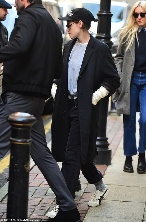 Kristen Stewart cuts a casual figure in a black coat and cap as she steps out in Manchester ahead of glitzy Chanel fashion show | Daily Mail Online Kristen Stewart Casual Outfits, Kristen Stewart 2024, Kristen Stewart And Karl Lagerfeld, Kristen Stewart Converse, Black Denim Outfit, Kristen Stewart Red Carpet, Kristen Stewart Chanel Photoshoot, Kristen Stewart In Suit, Kristen Stewart Paparazzi