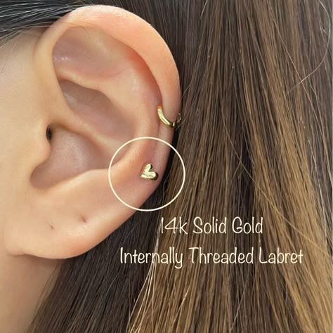 "Listing is Single - 1 piece IMPORTANT!! Please note that the photo is an extreme close up, please double-check the measurements prior to purchasing. Dainty 3D Heart Internally Threaded Labret Features: Material: 14k Solid gold Internally Threaded Labret Headpiece Size: 4.5mm x 4.5mm Gauge: 18g Bar Length: 6mm / 8mm Labret / Flat Back Ready for a Gift 🎁 * Return or Exchange in 14k Solid Gold * 1 - Customer MUST contact us within the 3 days window (starting from the delivery date reflected in th Mid Helix Piercing Studs, Mid Piercing, Midi Piercing, Mid Ear Piercing, Middle Helix Piercing, Mid Helix Piercing Ideas, Double Mid Helix Piercing, Mid Cartilage Piercing, Low Helix Piercing