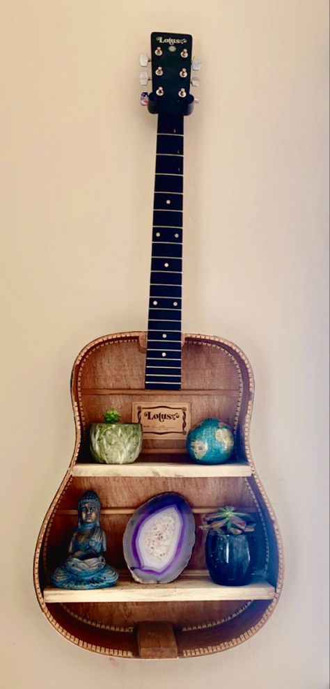 Opened up guitar hung on wall for shelves Displaying Guitars On Wall, Guitar Hung On Wall, Repurposed Guitar, Hanging Guitars, Guitar Shelf, Apartment Decorating Hacks, Guitar Crafts, Decorating Hacks, Guitar Diy