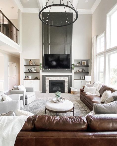 [CommissionsEarned] A Gorgeous Transitional Living Room With An Impressive Statement Fireplace, Open Shelving, And A Mix Of Leather And Neutral Seating. | Peaceandpinedesigns.Com For More #cozytransitionallivingroom Big Wall Decor Living Room Tall Ceilings Open Spaces, Living Room Tall Fireplace, Large Tv Living Room, Two Story Living Room Fireplace, Tall Living Room Wall Decor, Sitting Room Ideas With Fireplace, Fireplace Tall Ceilings, Contemporary Tv Room, High Ceiling Living Room Ideas