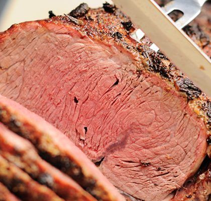 Smoked prime rib being sliced for the holidays Pioneer Woman Prime Rib, Strip Roast Recipe, Prime Rib Rub Recipe, Slow Roasted Ribs, Bottom Round Roast Recipes, Smoked Prime Rib Roast, Holiday Entrees, Beef Rib Roast, Boneless Ribs