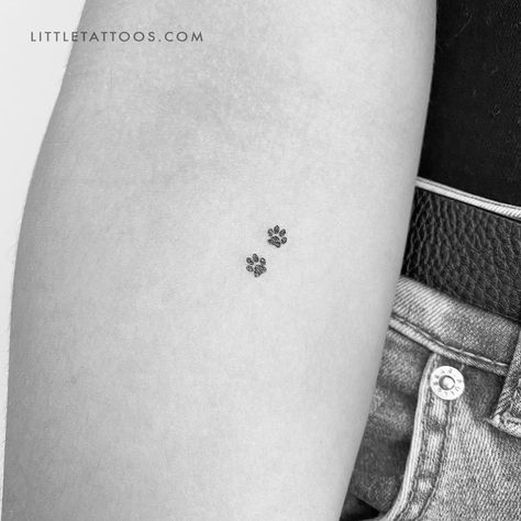 Set of three minimalist tiny pet paw print couple temporary tattoos. Paw print tattoos are a popular motif that can be chosen for a variety of reasons. Regardless of your reason for considering this type of tattoo, our dog paw print pair temporary tattoo offers you the ideal way to try before you buy. Our eco-friendly two pawprints fake tattoo features two tiny canine dog prints in black soy-based ink. With its small size, this is a design that will fit anywhere on your body. Don’t worry, you ge Tattoos Honoring Pets, Dog Tattoo Designs For Women, Small Tattoos For Pets, Two Paw Print Tattoo, Micro Paw Print Tattoo, Tiny Paw Print Tattoo Cats, Tiny Paw Tattoo, Kitty Paws Tattoo, Minimalistic Animal Tattoo