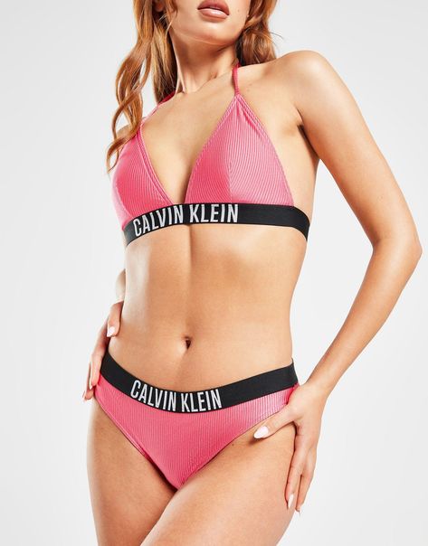 Step up your style by the pool with these women's Large Logo Rib Bikini Bottoms from Calvin Klein. In a Pink Flash colourway, these bottoms are cut from a recycled nylon fabric that's soft and stretchy to deliver all-day comfort. They feature a shiny rib texture to amp up the look and a medium raise elastic waistband for added support. Signed off with a Calvin Klein wordmark to the waistband. Machine washable. Please Note: Swimwear cannot be returned if the hygiene strip has been removed or is broken. | Our model is 5'7" and wears a size small. Pink Calvin Klein, Swim Shop, Jd Sports, Nylon Fabric, Buy Now Pay Later, Sport Fashion, The Pool, Elastic Waistband, Calvin Klein