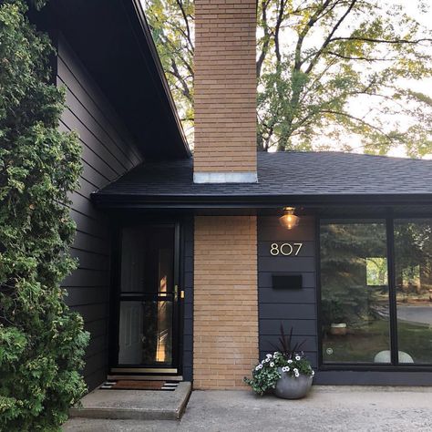 Mid-Century Modern Homes on Instagram: “Super impressive fixer upper work done by @ourhideawayhome. Winnipeg, Manitoba. 🙌🏻👏🏻” Mid Century Modern Exterior, Mid Century Exterior, Brick Chimney, Modern House Number, Exterior Makeover, Casa Exterior, Exterior Remodel, Exterior Paint Colors, Black Exterior