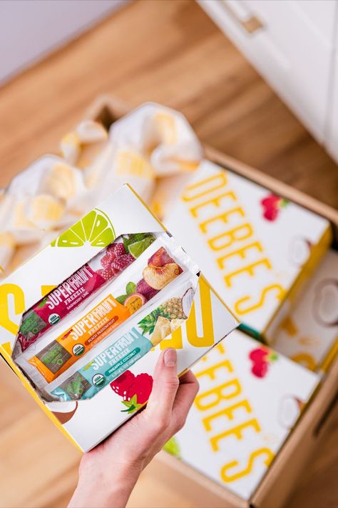 Hand holding box of DeeBee's SuperFruit organic freezer pops over a blurred background of DeeBee's packages on a kitchen floor. Tropical Snacks, Chocolate Drawing, Healthy Pantry, Creative Photography Projects, Brownie Ice Cream, Organic Snacks, Fruit Snack, Homemade Popsicles, Frozen Fruits