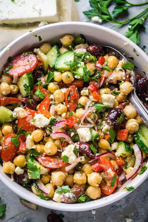 Whip up this easy and irresistible Greek chickpea salad with tender chickpeas, cucumbers, tomatoes, Kalamata olives, feta, and zingy Greek dressing. It's a Mediterranean delight! Salad Recipe With Chickpeas, Chickpea Feta Salad, Recipe With Chickpeas, Artichoke Pasta Salad, Garbanzo Beans Salad, Chickpea Salad Recipe, Greek Chickpea Salad, Greek Chickpeas, Chopped Vegetables