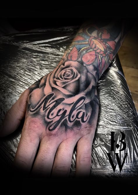 Rose hand tattoo. Men's tattoo. Child's name. By Beth wilde @ Wilde Ink, Wakefield. Cover Up Name Tattoos, Tattoos For Childrens Names, Hand Tattoos Pictures, Tato Nama, Name Tattoo On Hand, Rose Tattoo With Name, Small Wave Tattoo, Names Tattoos For Men, Tattoo On Hand