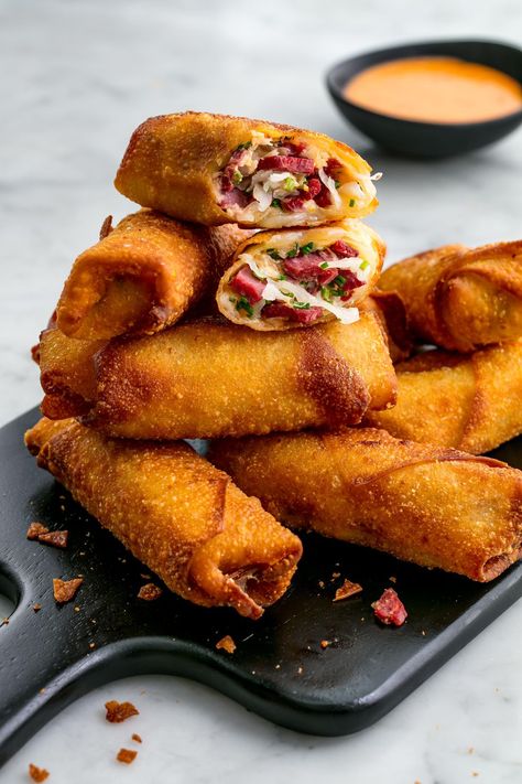 Frying egg rolls can sound intimidating, but it’s definitely worth it here. The high heat keeps the wrapper crispy and prevents the whole thing from exploding. (Trust us, we've tested them in the oven, and the results are way messier and sadly soggy. Get the recipe at Delish.com. #delish #easy #recipe #eggrolls #reuben #frying #Party #stpatricksday #saintpatricksday #crispy #fingerfoods Reuben Egg Rolls, Irish Appetizers, Holiday Party Appetizers, Superbowl Appetizers, Fall Appetizers, Christmas Recipes Appetizers, Egg Roll Recipes, Delish Recipes, Holiday Appetizers