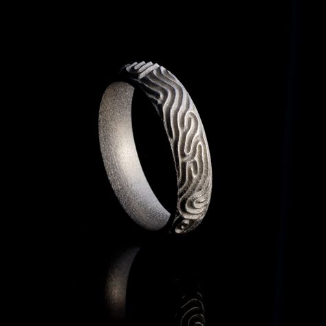 This modern, minimalist stainless steel ring is embossed with a complex pattern of ridges and valleys. The algorithmically generated pattern on the ring reminds us of the forms of brain corals, sand dunes and even fingerprints. The ring is made using direct metal 3d-printing from stainless steel powder. The ring is also available in polished sterling silver. About the Reaction Jewelry Collection Reaction is a 3d-printed jewelry collection inspired by biological morphogenesis. The designs are gro 3d Printed Ring, Brain Coral, Dune Jewelry, Slime Mould, 3d Printed Jewelry, Printed Jewelry, Stainless Steel Ring, Sand Dunes, Stainless Steel Band